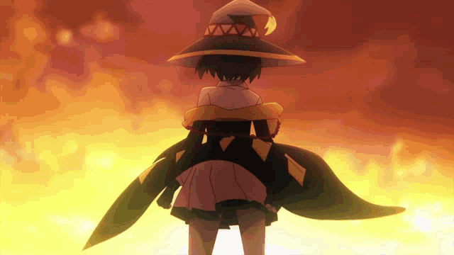 a girl in a witch costume stands in front of a fire