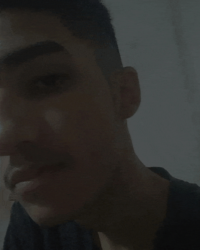 a close up of a man 's face with a beard looking at the camera .