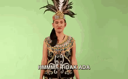 a woman in a traditional costume with feathers on her head .