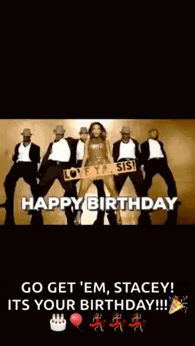 a woman is standing in front of a group of men holding a sign that says happy birthday .