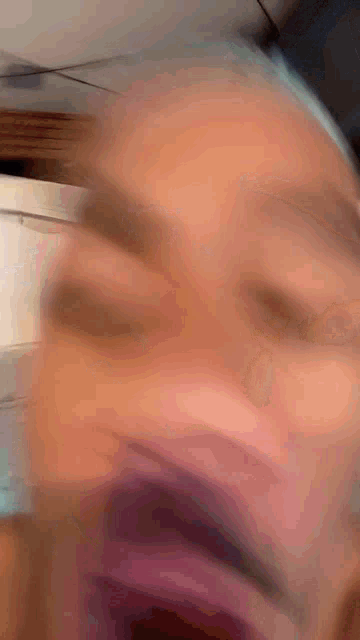 a close up of a person 's face with a blurry background