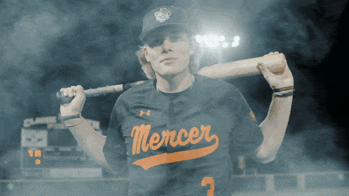 a baseball player for the mercer team holding a bat
