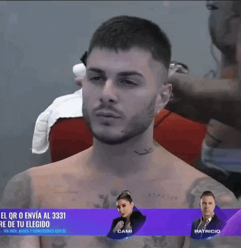 a shirtless man with a tattoo on his neck is being shaved