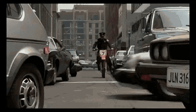 a man on a motorcycle has the number 7 on the front