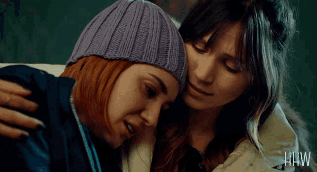 two women hugging each other with the word hw on the bottom left