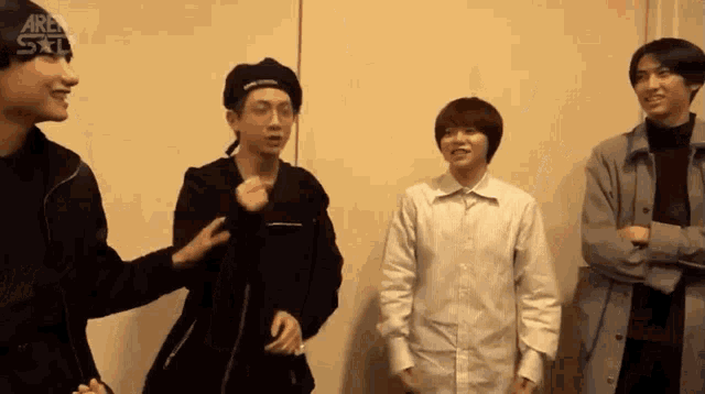 a group of young men are standing next to each other and one of them is wearing a beret