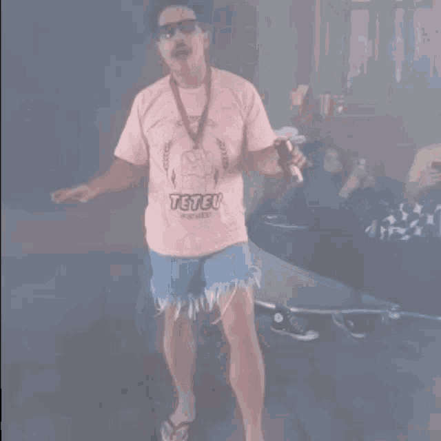 a man wearing a teteu shirt and shorts