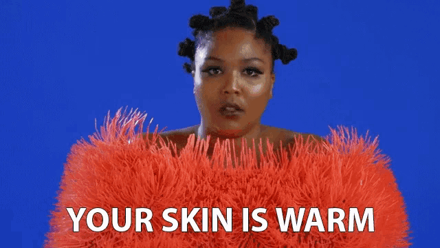 a woman wearing a red fur coat with the words " your skin is warm "