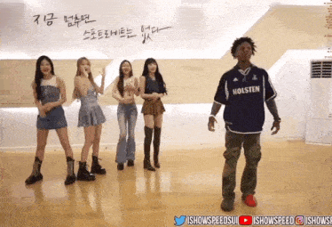 a man wearing a holsten shirt stands in front of a group of women
