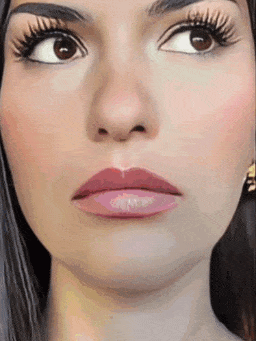 a close up of a woman 's face with long eyelashes