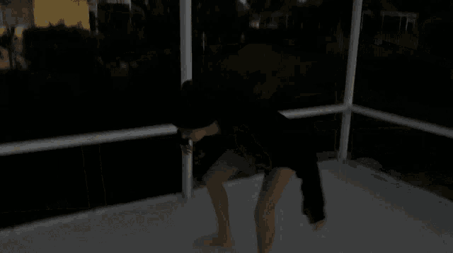 a blurry picture of a person standing in front of a window at night