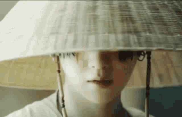 a close up of a person wearing a straw hat .