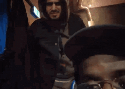 a man with a beard wearing a hooded jacket
