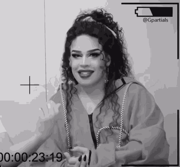 a black and white photo of a woman with curly hair and a gpartials logo in the corner
