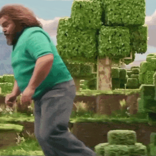 a man in a green shirt and gray pants is jumping in the air in a video game .