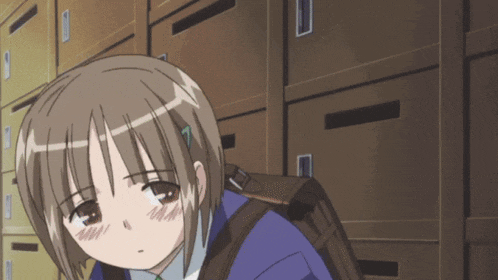 a girl with a backpack is standing in front of a wall of lockers