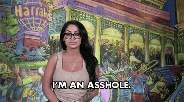 a woman wearing glasses says i 'm an asshole in front of a harrah 's mural .