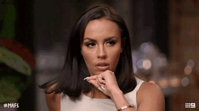 a woman with # mafs written on the bottom of her screen