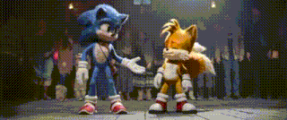 sonic the hedgehog and tails the fox are standing next to each other .