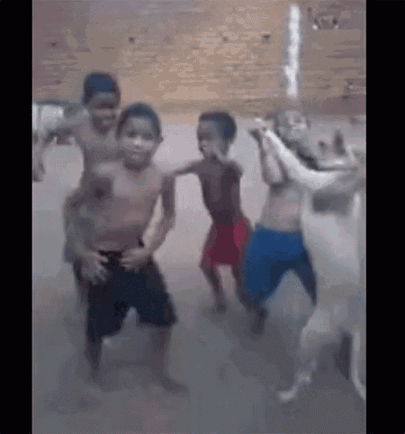 a group of boys are dancing with a dog