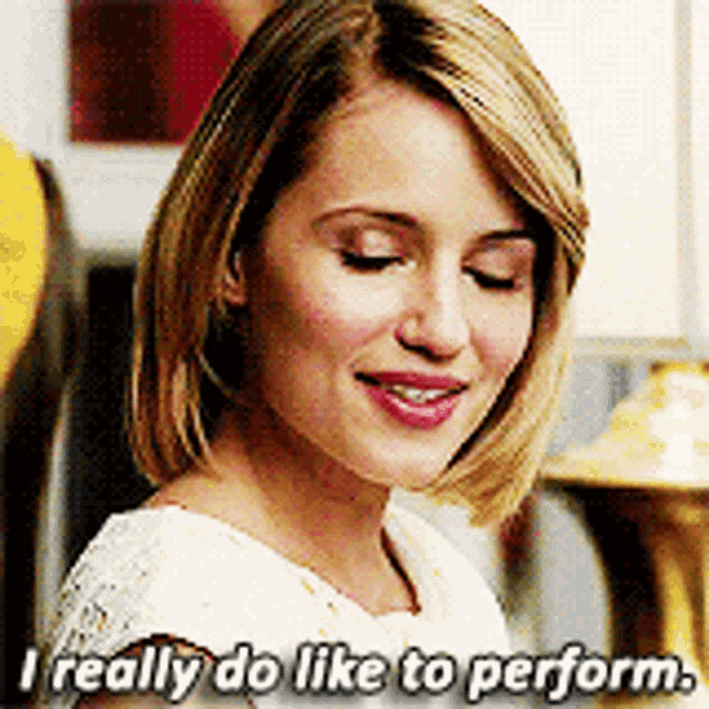 a woman with short blonde hair is smiling and says i really do like to perform .