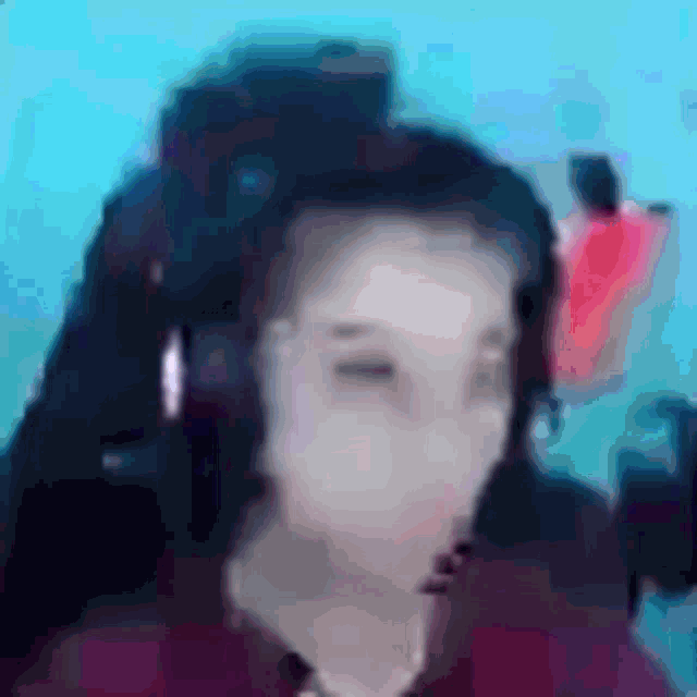 a blurry picture of a woman wearing headphones and a headset .