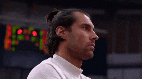 a close up of a man 's face with a ponytail
