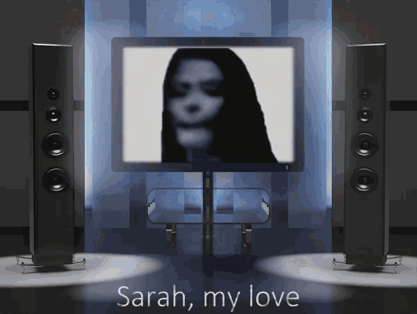sarah my love is displayed on a screen in front of two speakers