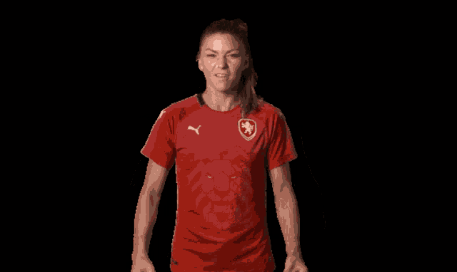 a woman in a red shirt with a lion on it