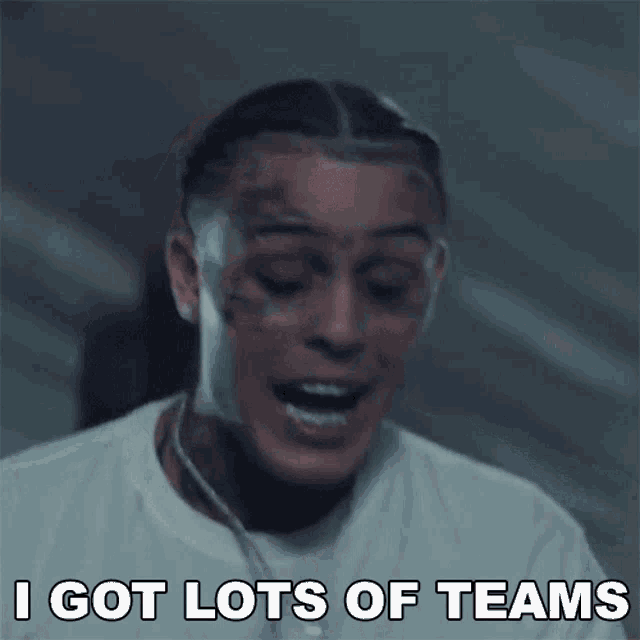 a man with a tattoo on his face is smiling and says i got lots of teams