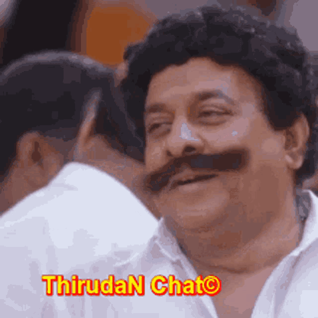 a man with a mustache is smiling and says thiruda n chat .