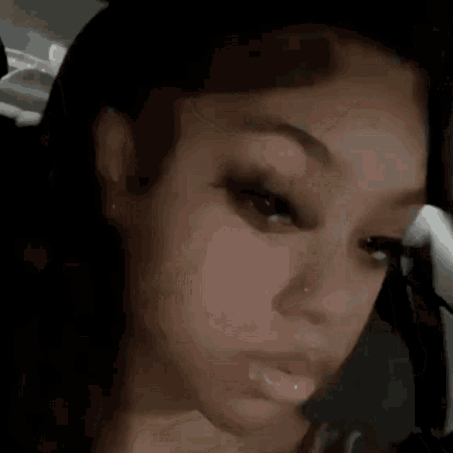 a close up of a woman 's face with a nose ring on it .