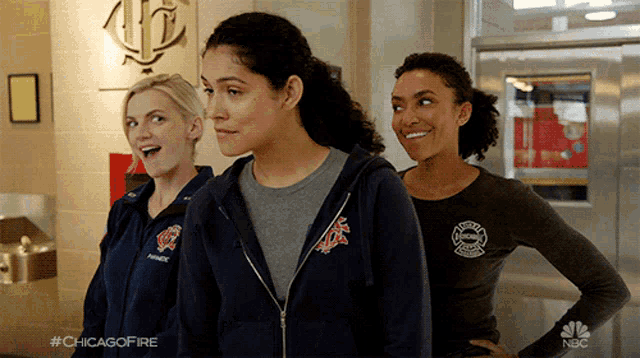three female firefighters are standing next to each other with the hashtag #chicagofire on the bottom