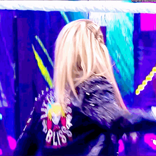 a woman is wearing a jacket with bliss on the back
