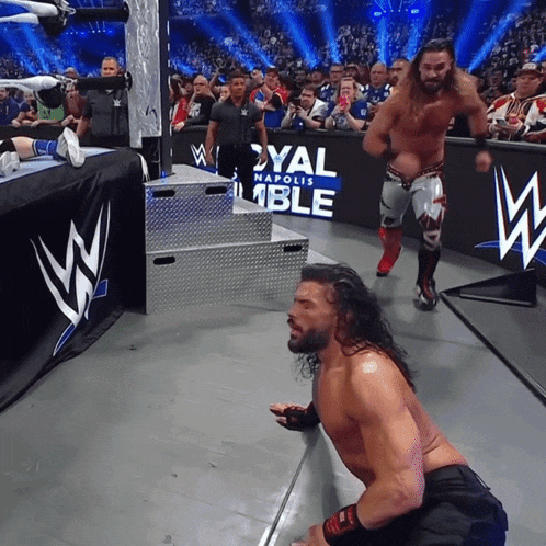 a wrestler is kneeling down in front of a sign that says royal napoli ble