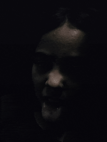 a close up of a woman 's face with her tongue out