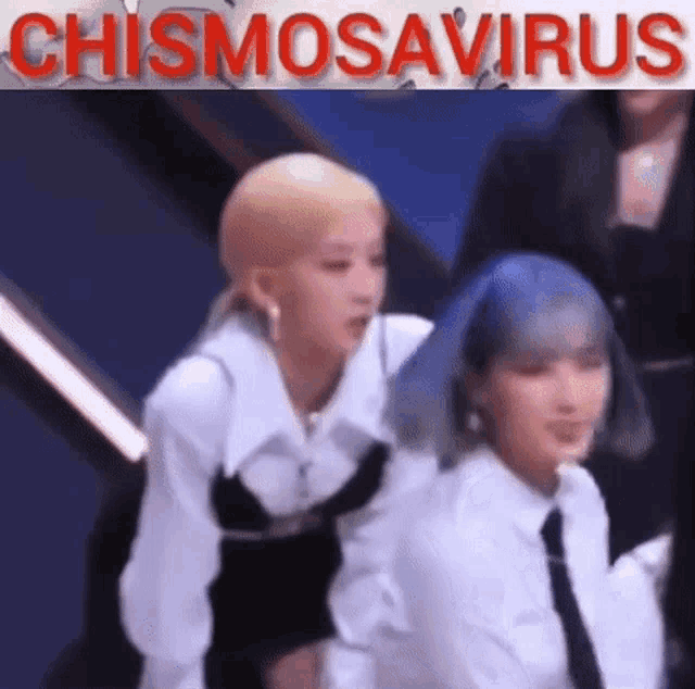 two women with blue hair are standing next to each other in front of a sign that says chismosavirus .