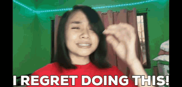 a woman in a red shirt is crying and says i regret doing this