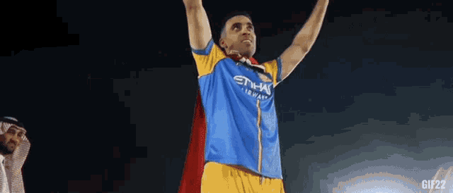 a man wearing a blue and yellow shirt that says etihad airlines