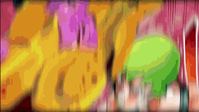 a blurry picture of a person with a green ball in the background