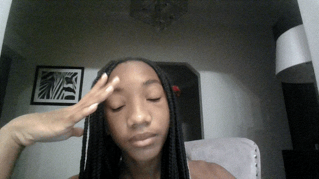 a woman 's hand rests on her forehead in front of a framed picture of a zebra