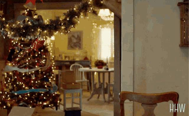 a christmas tree in a living room with the word hw on the bottom