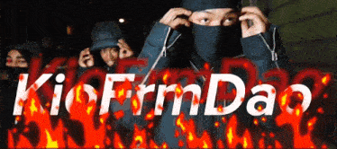 a man with a mask on his face is surrounded by flames and the words kio firm dao
