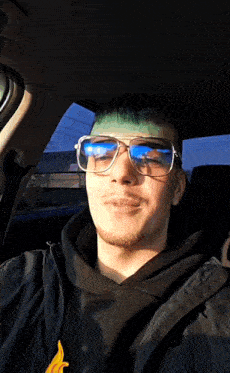 a young man wearing sunglasses and a black jacket