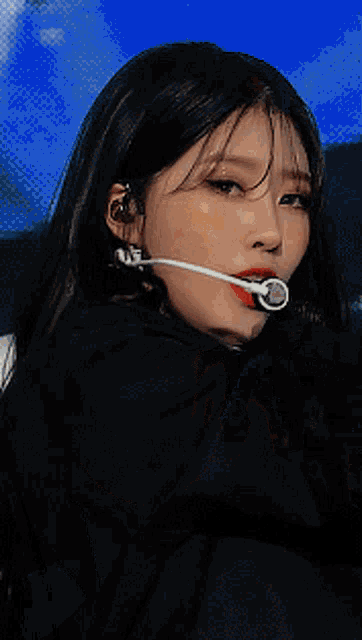 a close up of a woman wearing a microphone on her head