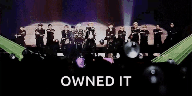 a group of people are standing on a stage with the words owned it above them