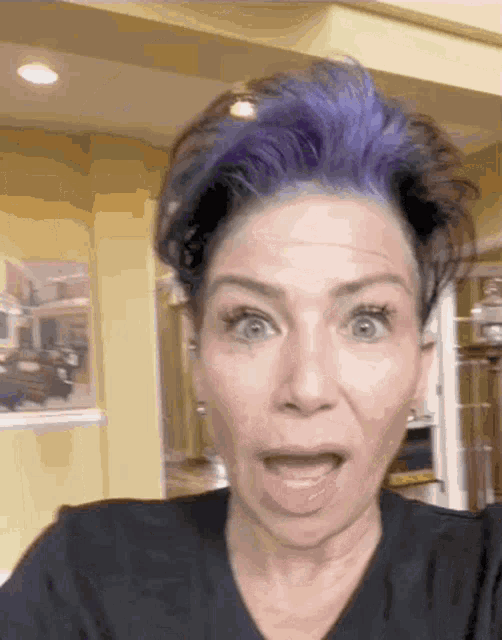 a woman with purple hair making a funny face