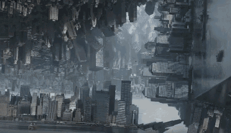 an aerial view of a city with a lot of buildings and a river in the background .