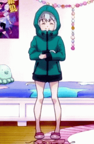a girl is standing in front of a bed wearing a green jacket and slippers .