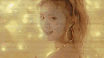 a close up of a woman 's face with a ponytail and a gold chain around her neck .